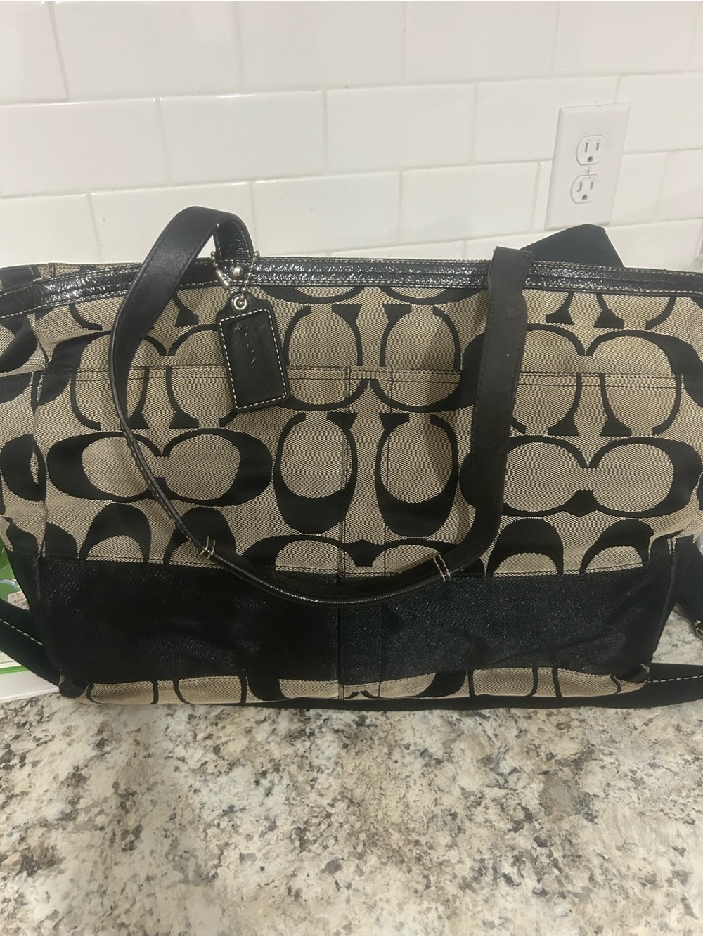 Coach Black and Khaki Signature Canvas diaper bag.